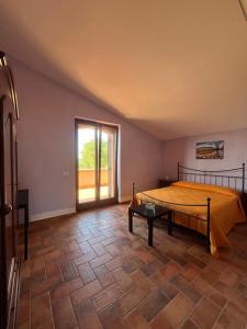 a bedroom with a bed and a large window at Tenuta Raimo in Altavilla Silentina +44 photos