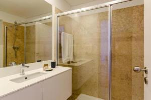 a bathroom with a sink and a shower at Light House Apartments - Casas da Baixa in Lisbon +19 photos