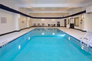 une grande piscine avec de l'eau bleue dans un immeuble dans l'établissement Hampton Inn & Suites Spartanburg-I-26-Westgate Mall, à Spartanburg