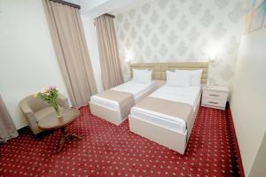 Voodi või voodid majutusasutuse Welcome Inn Hotel toas