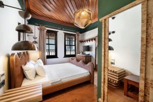 a bedroom with a bed with a wooden headboard at House 5 Hotel in Antalya