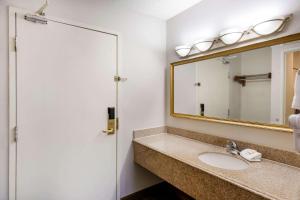 a bathroom with a sink and a mirror at Baymont by Wyndham Meridian in Meridian +19 photos