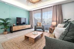 a living room with a couch and a tv at INF31J - Stunning holiday home next to beach in Estepona