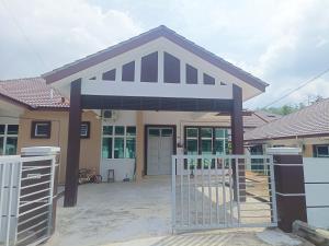 a house with a gate in front of it at 4D Homestay TSNU Tampin with pool n Bbq set in Tampin