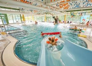 a group of people in a swimming pool at Apartmán REZE Šumava in Železná Ruda