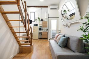 a living room with a couch and a staircase at Estudio en Plaza de España in Madrid