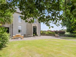ein Haus mit einem Picknicktisch davor in der Unterkunft The Haw Country Home in Bushmills
