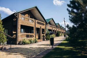 a large wooden building on the side of a street at Парк-Готель CASPIY in Zhovte