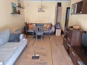 a living room with a couch and a table and chairs at Apartman Becici beach in Bečići