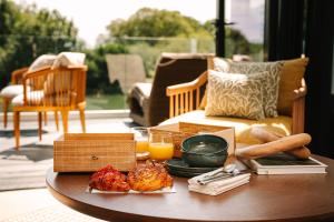 a coffee table with food and orange juice on it at South Lodge in Lower Beeding