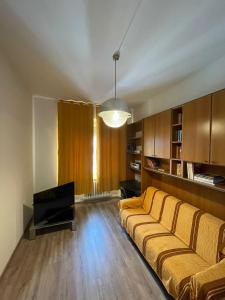 Una sala de estar con un sofá y un televisor. en B&B Il Glicine Pescara centro, en Pescara