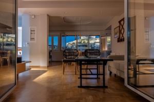a living room with a table and a couch at Unique 2BR Penthouse with Stunning Acropolis View in Athens