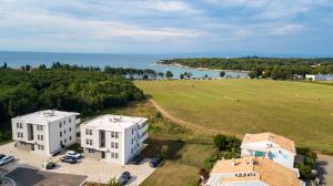 an aerial view of two white buildings and a field at Baden Resort Bašanija, Umag-with Sea View, Parking and 300m from the beach in Bašanija