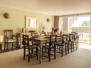 a dining room with a table and chairs at Vine Cottage in Shepton Mallet +12 photos