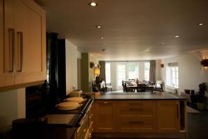 a kitchen with a counter and a dining room at Vine Cottage in Shepton Mallet