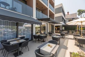 an outdoor dining area with tables and chairs at Hotel Squero in Rovinj