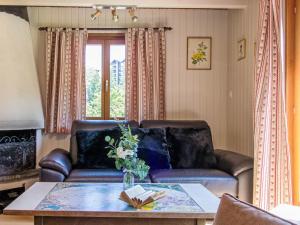 a living room with a leather couch and a table at Chalet Peer Gynt by Interhome in Nendaz +42 photos