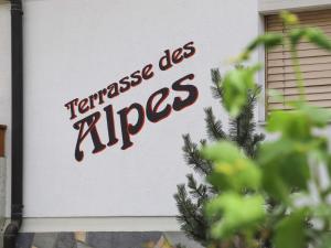a sign on the side of a building with the words tennisiasappers at Apartment Terrasse Des Alpes 917 by Interhome in Crans-Montana