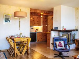 a living room with a table and a kitchen at Apartment Chaedoz 43 by Interhome in Nendaz
