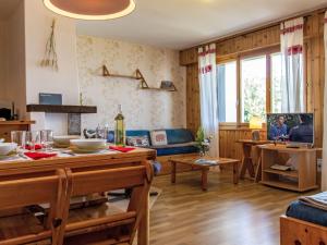 a living room with a couch and a table with a tv at Apartment Chaedoz 43 by Interhome in Nendaz +27 photos