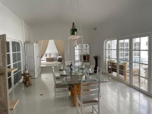 a dining room with a glass table and chairs at Große sonnendurchflutete Wohnung in Costa Calma +36 photos