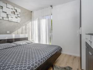 a bedroom with a bed and a window at Holiday Home Forest Fairy by Interhome in Raša