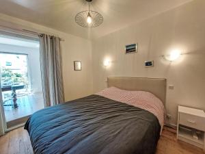 a bedroom with a bed and a large window at Holiday Home Bon Port by Interhome in Saint-Philibert