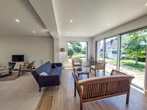 a living room with a blue couch and chairs at Holiday Home Bon Port by Interhome in Saint-Philibert