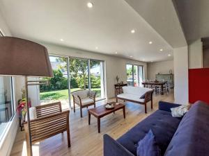 a living room with a blue couch and a table at Holiday Home Bon Port by Interhome in Saint-Philibert