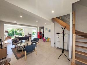 a living room with a staircase and a dining room at Holiday Home Bon Port by Interhome in Saint-Philibert +19 photos