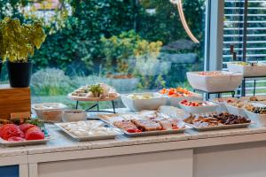 a buffet with different types of food on a table at Hotel Oliwski in Gdańsk