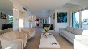 a living room with a couch and chairs and a table at VILLA BIANCA 10, Emma Villas in Misano Adriatico