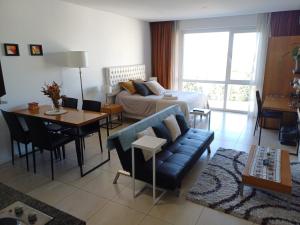 a living room with a couch and a bed and a table at Condominios W Nordelta Bahia,Tigre,Parking,Gym in Tigre