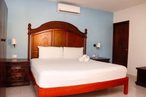 Postel nebo postele na pokoji v ubytování Hotel Quinta Izamal