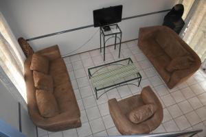 an overhead view of a living room with brown furniture at Pendleberry Grove Holidays in Bela-Bela