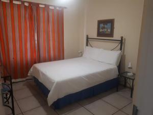 a bedroom with a bed in a room at Pendleberry Grove Holidays in Bela-Bela +25 photos