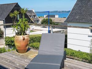 a balcony with a bench and a vase on a deck at Holiday Home La Bellevue de Pen Ar Rhun by Interhome in Locquirec
