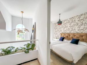 a bedroom with a bed and plants in it at Hanami Casa Principe Felipe in Estepona +33 photos
