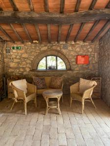 a room with chairs and a table and a window at Hotel Il Pietreto in Colle di Val d'Elsa +45 photos