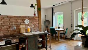 a kitchen with a sink and a brick wall at Villa Zeppelin 2 in Joachimsthal