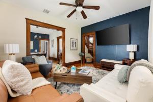 a living room with a couch and a tv at Ninth Street Urban Retreat in Traverse City