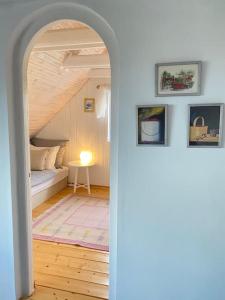 an archway leading to a bedroom with a bed at Stockholm Vendégház in Vác