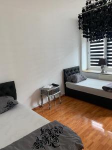 a bedroom with a bed and a couch and a window at Unterkunft Mara in Oberhausen