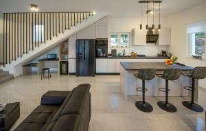 a kitchen and living room with a couch and a table at Pet Friendly Home In Sibenik in Šibenik