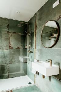 a bathroom with a sink and a mirror at The Goat House Retreat in Cranley