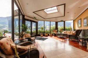 an open living room with a lot of windows at Olden Fjordhotel in Olden