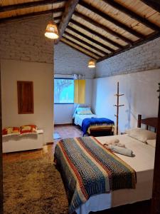 a bedroom with two beds in a room at Chalé Boa Vista in Carrancas +3 photos