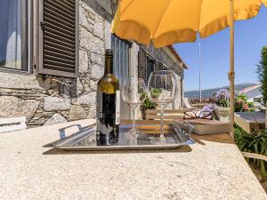 a bottle of wine and two glasses on a table at Holiday Home Do Condado by Interhome in Caminha