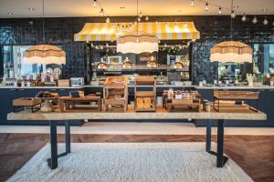 a restaurant with a large table in a room at Doubletree By Hilton Nice Centre Iconic in Nice