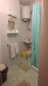 ein Badezimmer mit Toilette, Waschbecken und Spiegel in der Unterkunft Studio apartman za 2 uz more in Makarska